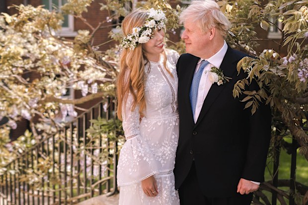 British Prime Minister Boris Johnson poses with his wife Carrie Johnson in the garden of 10 Downing Street following their wedding at Westminster Cathedral, May 29, 2021