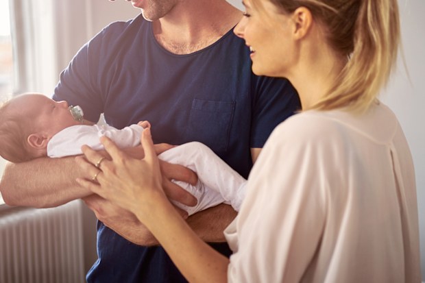 Shot of a happy young couple bonding with their baby girl at home