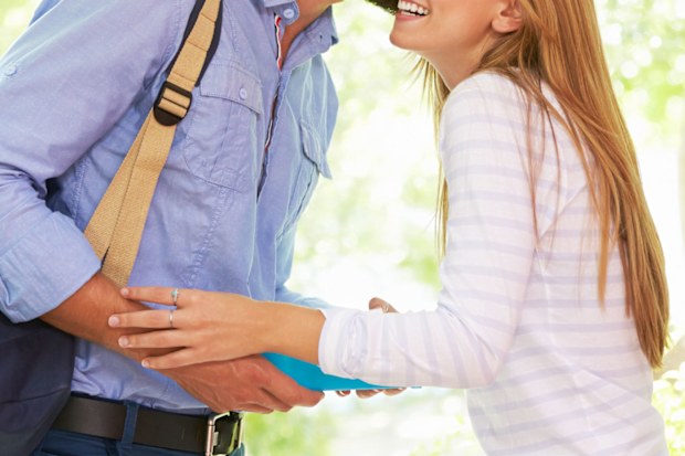 Man kissing woman goodbye.