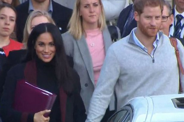 Meghan Markle holding folders as she arrives in Sydney in 2018