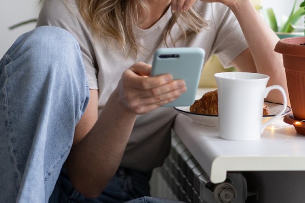 Woman listening to podcast on phone