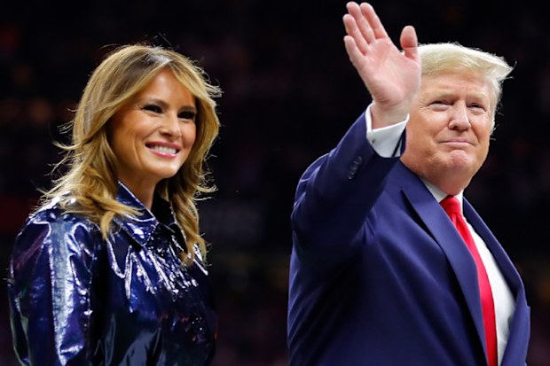 President Trump escorts Melania off the field prior to the College Football Playoff National Championship Game on January 13, 2020.