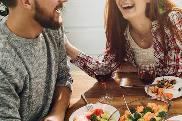 Two friends chatting over dinner