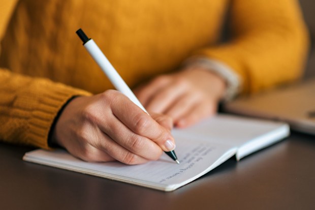 Woman writing in journal