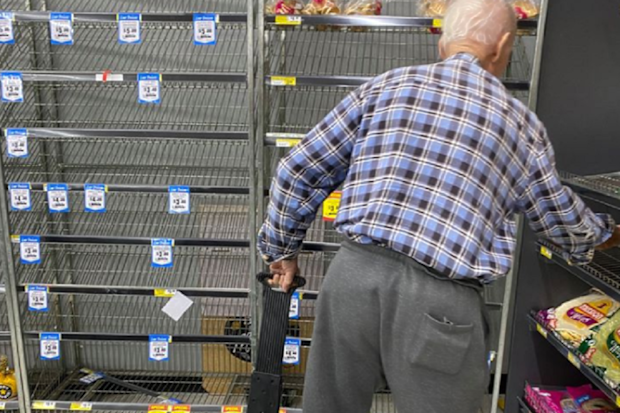 Man at IGA in Australia looking for bread.