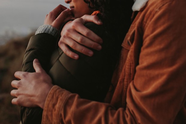 Man and woman embracing.
