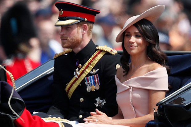 Britain's Prince Harry, left, and Meghan, Duchess of Sussex ride in a carriage to attend the annual Trooping the Colour Ceremony in London, Saturday, June 9, 2018.(AP Photo/Frank Augstein)
