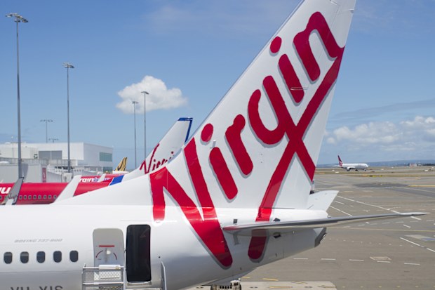 "Sydney, NSW, Australia - December 12, 2012: Virgin Australia plane with stairs waiting for passengers to board at Sydney Airport"