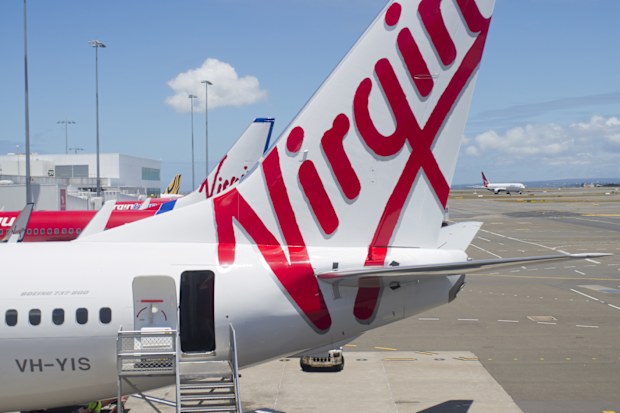 "Sydney, NSW, Australia - December 12, 2012: Virgin Australia plane with stairs waiting for passengers to board at Sydney Airport"