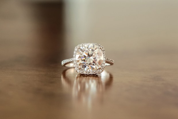 Stock image of an engagement ring sitting on a table