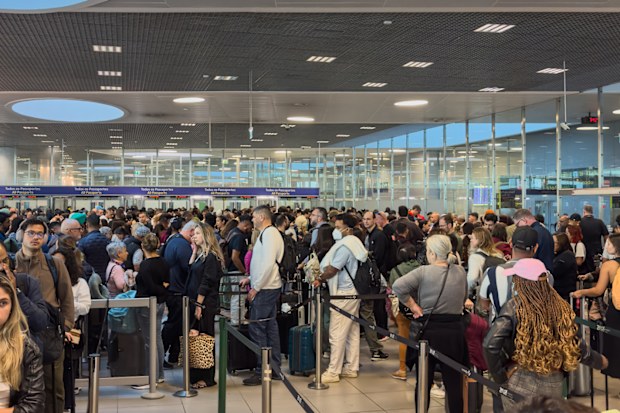 Queues of passengers at Lisbon Humberto Delgado Airport Arrivals waiting for immigration border control processing for up to 3 hours in June 2025