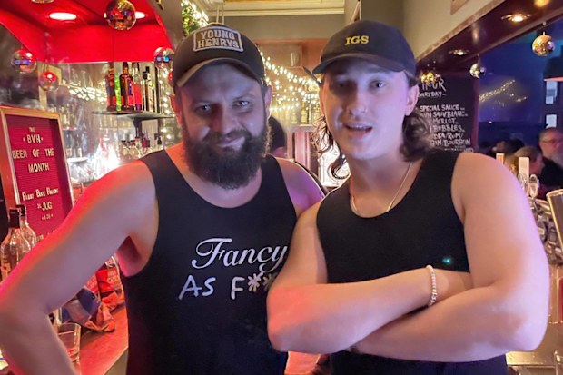 Luke at work behind the bar with a colleague.