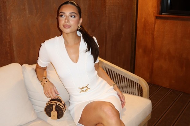 Costeen Hatzi poses in a chic white dress.