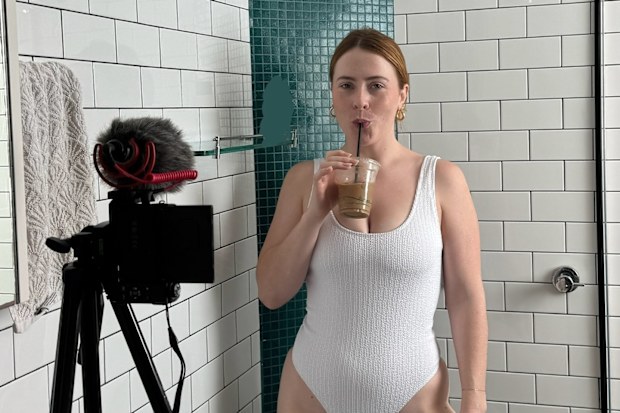 Lucy Neville poses while filming in her bathroom.