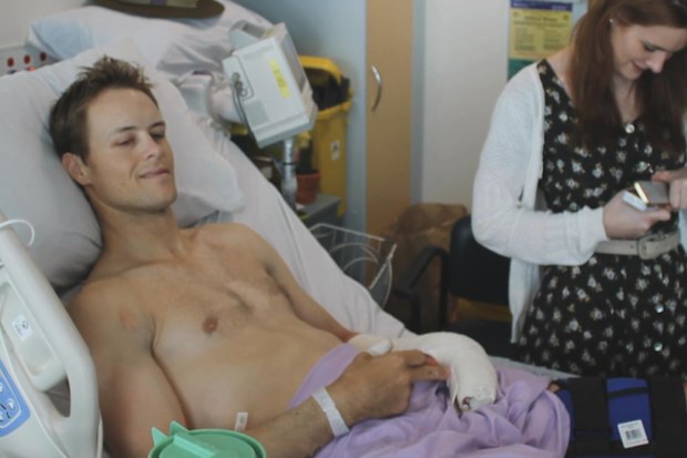Curtis McGrath in hospital with Rachel McGrath by his side