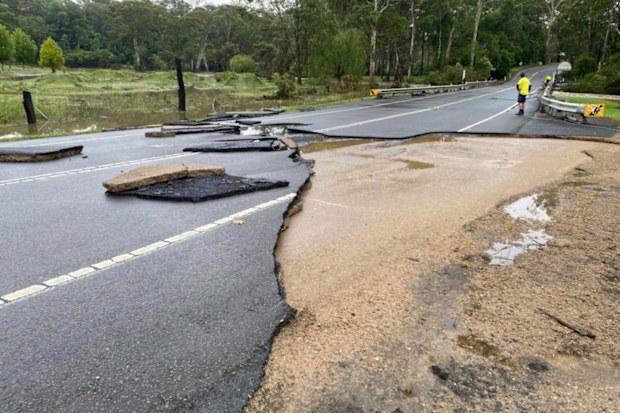 Floodwaters caused a portion of the road in north-west Sydney to wash away. 