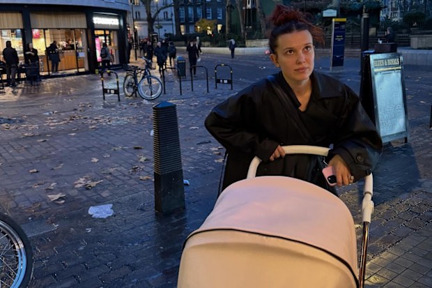 Millie Bobby Brown pushing her daughter in a pram
