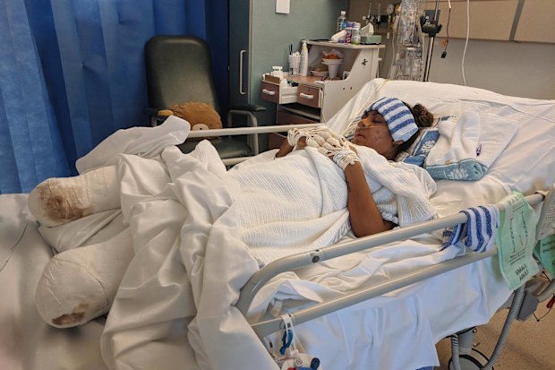 Juttima Chinnasri in hospital after having her fingers and lower legs amputated.