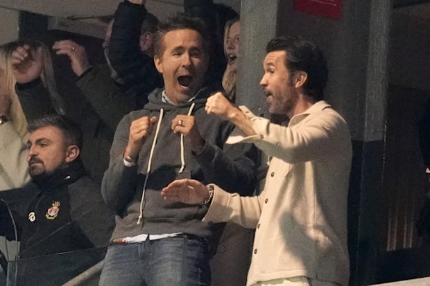 Wrexham co-owners Ryan Reynolds and Rob Mac celebrate after VAR ruled the first Wrexham goal onside.