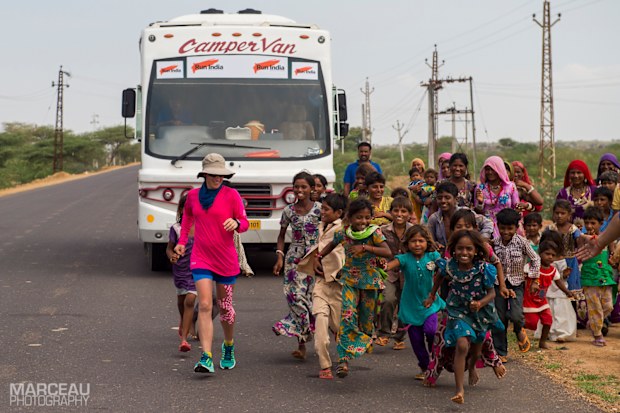 Local children running alongside Samantha during her ultra-marathon journey across India.