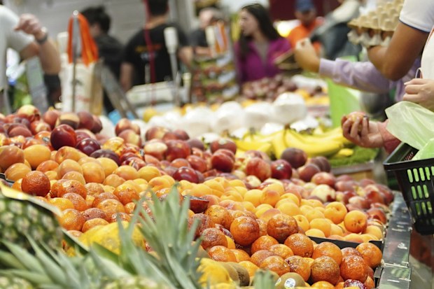 General photo of people shopping for fruits and vegetables at the Queen Vic Market.