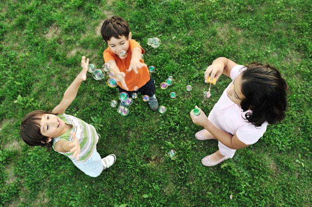 children blowing bubbles