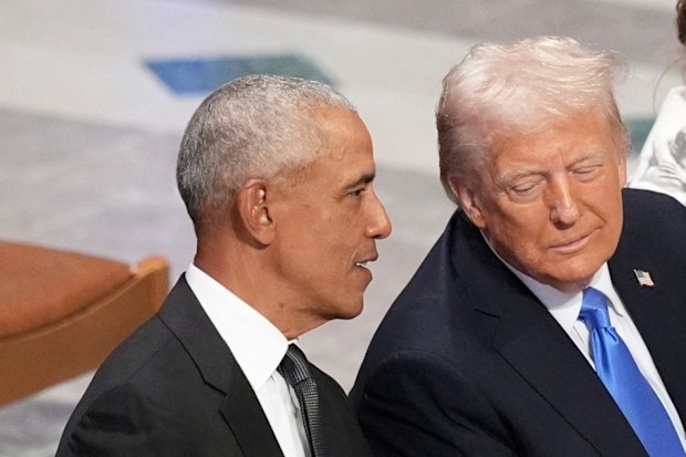 FILE - Former President Barack Obama talks with then President-elect Donald Trump as Melania Trump reads the funeral program before the state funeral for former President Jimmy Carter at Washington National Cathedral in Washington, Jan. 9, 2025. (AP Photo/Jacquelyn Martin, File)