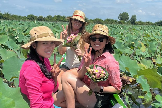 Leanne Savage on a lotus lake in Cambodia with members of the Acala Stem team.