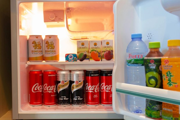 CHIANGMAI,THAILAND- December 28, 2020: cold beverage cans and bottles inside mini hotel fridge at night