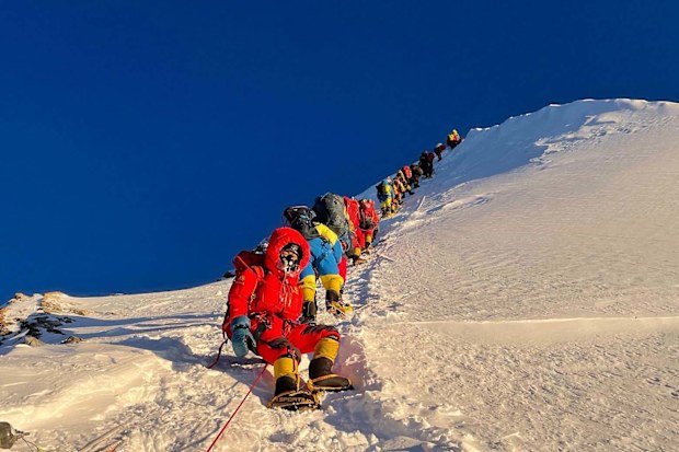 	Mountaineers as they climb during their ascend to summit Mount Everest in May 2021.