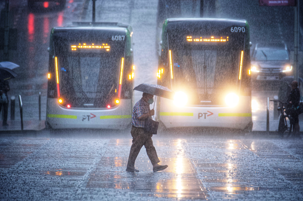 Photo of people running for cover during a thunderstorm in Melbourne on Thursday 2 November 2021.