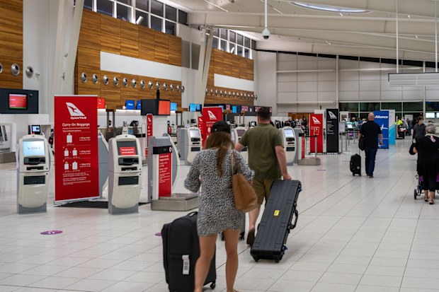 Adelaide, Australia - 1 Feb 2021: A few people in Adelaide airport walking to the check-in counter. South Australia is currently in the 'very low-risk' category and so South Australian can travel interstate freely.