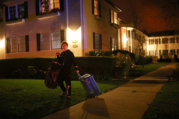 A man leaves after an evacuation order as a wildfire burns in the Pacific Palisades neighborhood of west Los Angeles on January 7.