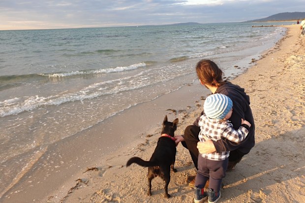 Chris with his son Oscar and dog on the beach