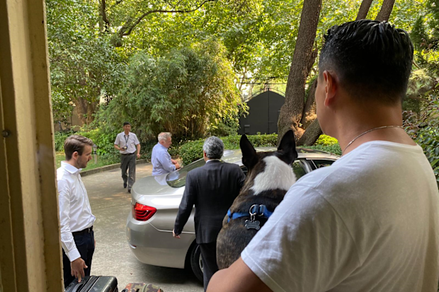 Mike prepares to drive off for an interview with China's secret police.