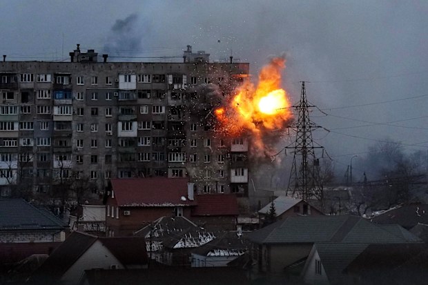 An explosion is seen in an apartment building after Russians army tank fires in Mariupol, Ukraine, Friday, March 11, 2022. (AP Photo/Evgeniy Maloletka)