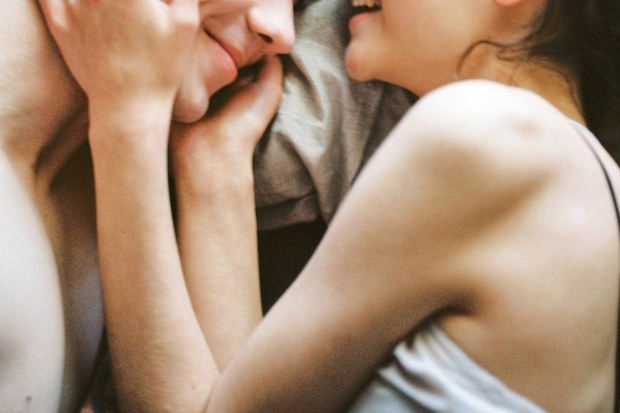 Stock photo of a woman and man in bed together.