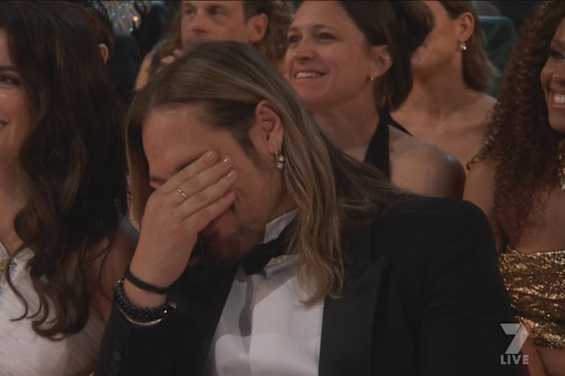 Zoe Saldana accepts the Oscar for Best Actress in a Supporting Role.
