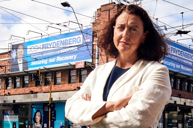 Independent for Kooyong Dr Monique Ryan at Camberwell Junction in Melbourne, standing in front of billboards of Josh Frydenberg.
