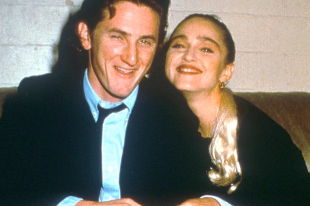Sean Penn and Madonna relax while attending an AIDS benefit November 11, 1987 in Los Angeles. 