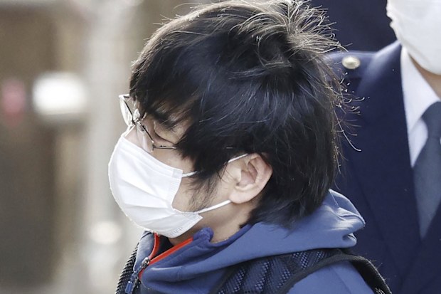 Tetsuya Yamagami, the alleged assassin of Japan's former Prime Minister Shinzo Abe, led by police officers, enters a police station in Nara, western Japan, on Jan. 10, 2023.  