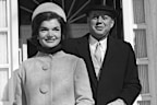 (Original Caption) Headed For the White House. Washington, D.C.: John F. Kennedy, wearing top hat, and his wife, Jacqueline, leave their Georgetown home for the White House, where they had coffee with President Eisenhower prior to inauguration ceremonies.