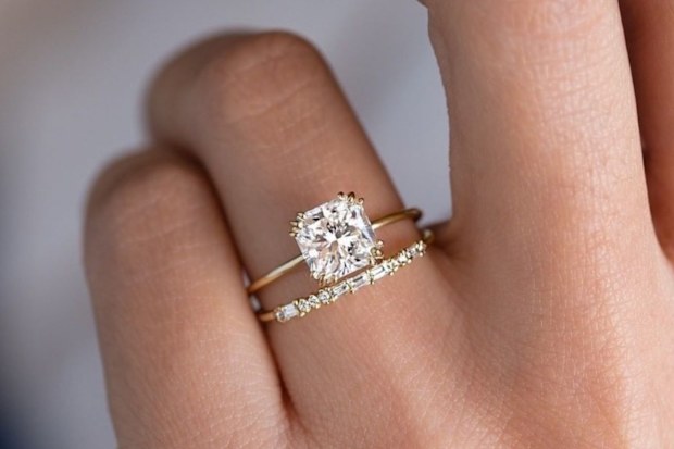 Stock photo of an engagement ring and wedding ring on a woman's finger