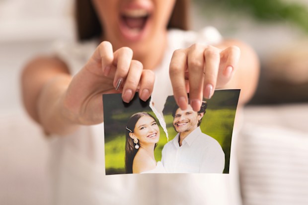 Divorce Concept. Unrecognizable Furious Girl Tearing Apart Photo Of Happy Couple Indoor. Selective Focus, Panorama, Cropped