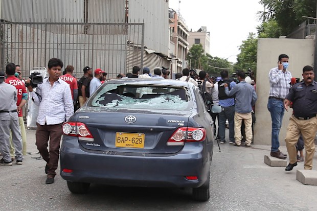 Pakistani security officials inspect the scene of an attack by unknown gunmen at Karachi Stock Exchange in Karachi, Pakistan, 29 June 2020. At least four gunmen and two civilians were reportedly killed and security forces have cordoned off the area as fighting is currently ongoing