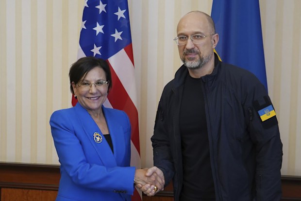 Former US commerce secretary Penny Pritzker shakes hands with Ukraine's Prime Minister Denys Shmyhal.