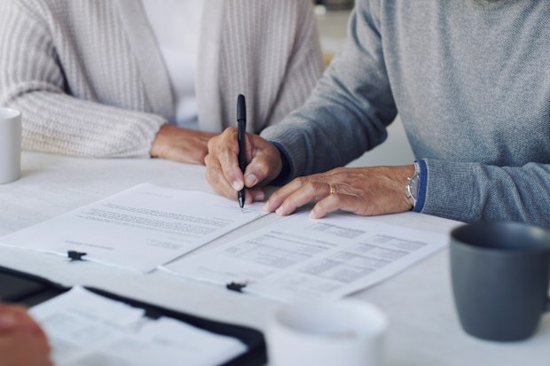 Older couple signing will