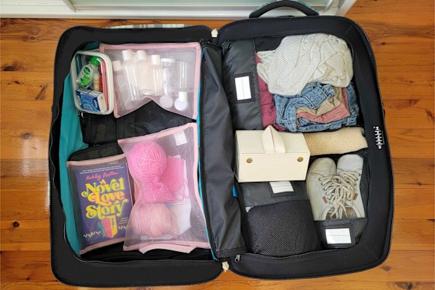 Suitcase packed using compression bags, mesh pouches and jewellery organiser from Kmart