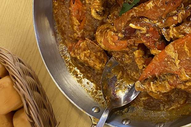 large bowl of JUMBO Seafood chilli crab with dinner rolls