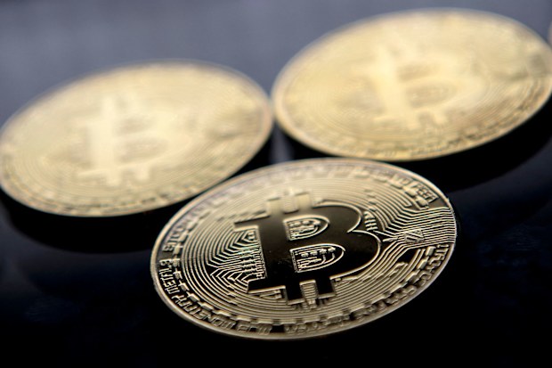 Gold-plated souvenir Bitcoin coins are arranged for a photograph in London in November 2017. Bitcoin hit a new record above $80,000 on November 10.